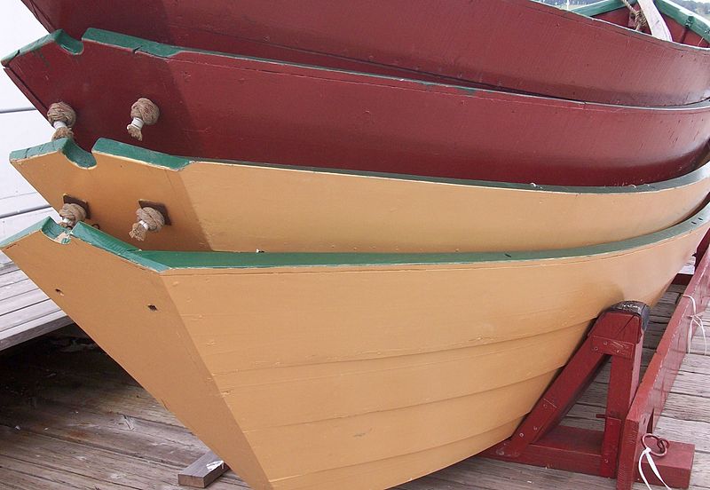 Photo of 4 dories, stacked on top of each other.