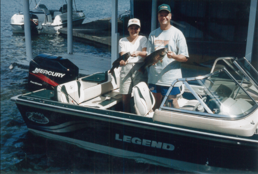 Two people in Legend Fishing boat. Showcasing how long we have been using the innovative curved windshield.