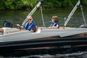 Seniors enjoying time on a Legend Vibe Cognac deck boat