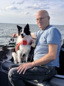Legend Boat owner hanging out with his dog on the water
