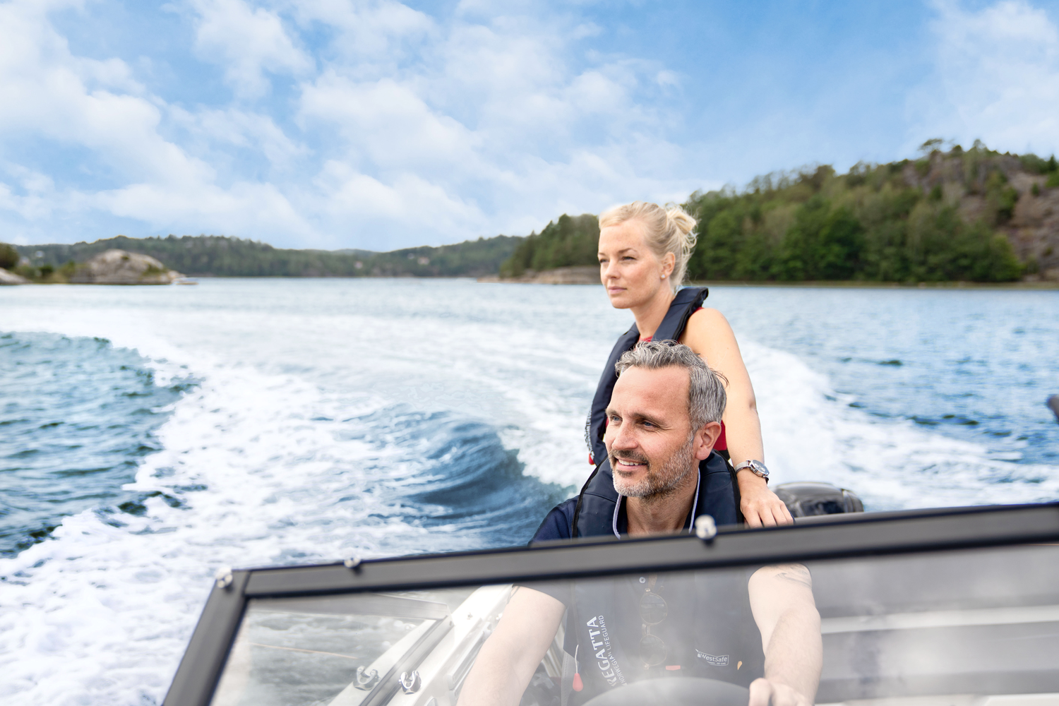 Legend Boats - A couple driving a boat together